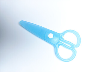 Blue scissors on a white background, special scissors for children can only be used to cut paper