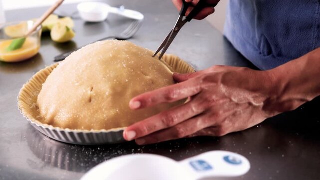 Chef hands trimming pie crust with scissors &ndash; Holiday preparation, Thanksgiving dessert, Christmas pastry detail concept