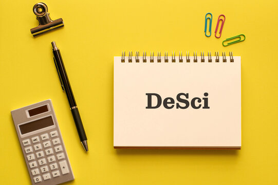 There is notebook with the word DeSci. It is an abbreviation for DeSci as eye-catching image.