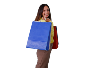 Cheerful woman smiling, walking with shopping bags over her shoulder, feeling satisfied and content after buying new things