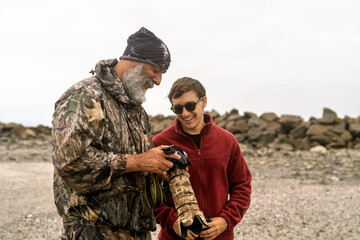 Wildlife photographers reviewing images on camera screen