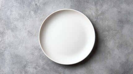 A simple white plate on a textured gray background, perfect for showcasing dishes.