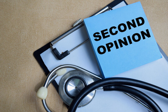 Concept of second opinion write on sticky notes isolated on Wooden Table.