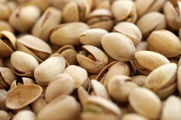 Tasty unpeeled pistachios as background, top view flat lay background