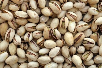 Many tasty unpeeled pistachios top view flat lay background pattern