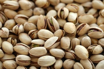 Many tasty unpeeled pistachios top view flat lay background pattern