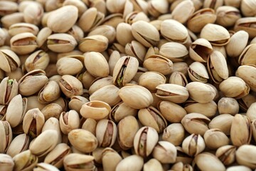 Many tasty unpeeled pistachios top view flat lay background pattern