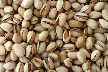 Many tasty unpeeled pistachios top view flat lay background pattern