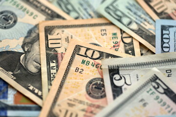 Big amount of different dollar bills close up. Hundred fifty twenty ten and five dollar banknotes