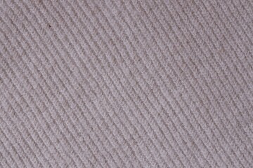 Texture of knitted pastel pink sweater, close-up texture of beige pink