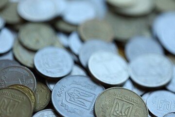 Metal coins of Ukraine of different denominations are scattered. Money texture, business background.