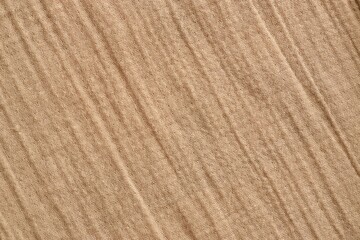 Texture of crumpled linen fabric under natural light in peach fuzz color