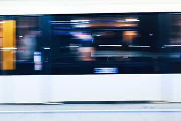 A fast-moving subway train captured with intentional motion blur as it arrives at an urban platform in Budapest, Hungary