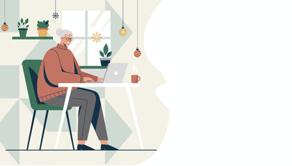 Elderly woman working on a laptop at a cozy winter home office desk Copy space provided