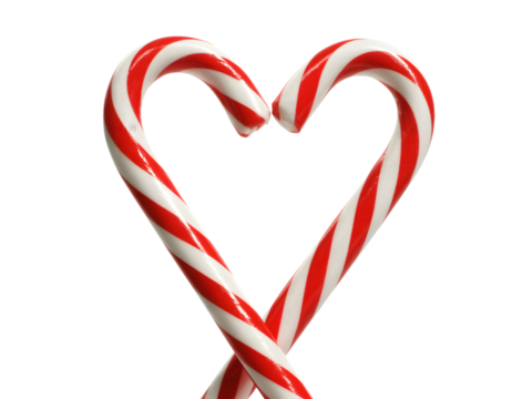 Sweet red and white striped candy canes form a heartwarming Christmas love symbol on a black background. Ideal for holiday greetings, festive designs, and romantic seasonal marketing content.