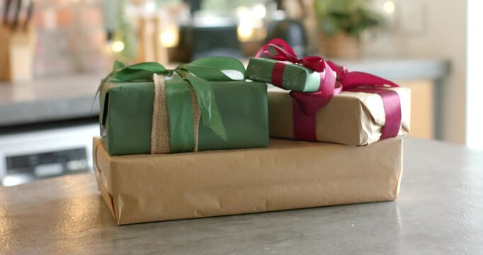 Lens focus shift is revealing three gift boxes on kitchen countertop to highlight wrapping details