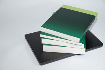 Stack of Books on Laptop Computer