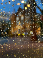 Old church seen through the raindrops on a window.