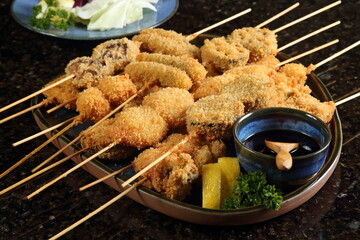 Kushi Ague, skewers of meat and vegetables served with Japanese-style Worcestershire sauce.