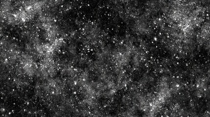 Obraz premium A textured black and white image resembling a starry night sky with scattered specks and a cosmic feel.
