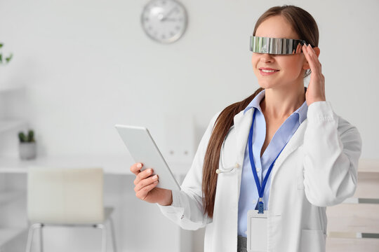 Female doctor in goggles with tablet computer at hospital