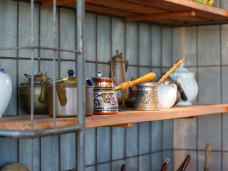 Shelf with various pots and utensils for brewing coffee
