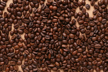 Scattered coffee beans on beige background