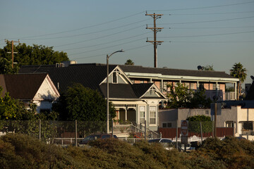 Power line framed afternoon view of historic homes in the Lincoln Heights neighborhood of Los Angeles, California, USA.