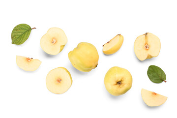 Sweet ripe quinces with cut pieces and leaves on white background