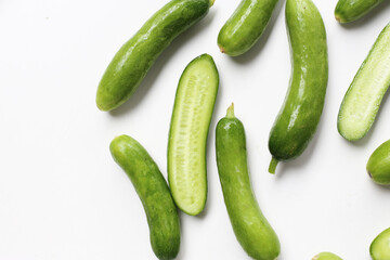 Fresh mini baby cucumbers on white background