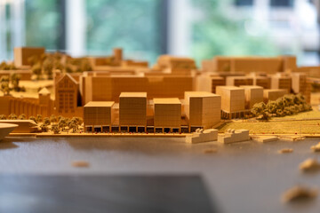 Wooden cityscape architectural model features buildings, waterfront, trees, urban planning concept