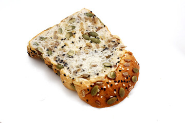Sliced multigrain bread topped with pumpkin seeds, sunflower seeds, sesame, and black sesame.