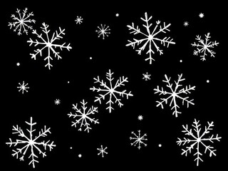 A pattern of white doodle snowflakes on a solid black background. This high-contrast winter design has a whimsical, festive look perfect for holiday and seasonal projects.