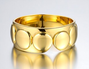 Gleaming golden bangle with a series of rounded, raised decorative elements, set against a studio background