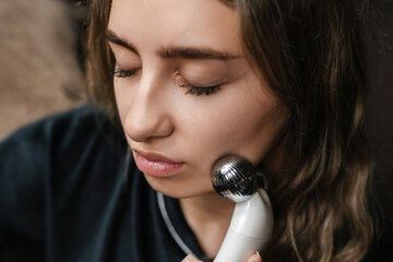 demonstration of precise microcurrent facial technique emphasizing warmth and clinical clarity