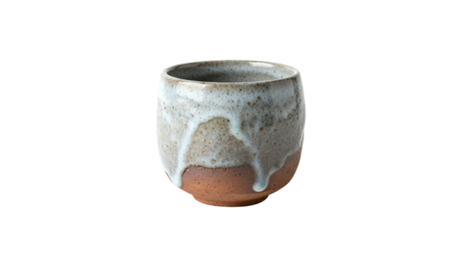 A rustic handmade ceramic teacup with a dripping white and grey glaze over a textured brown clay base, showcasing traditional wabi-sabi pottery craftsmanship