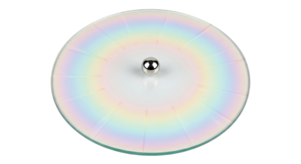 A round, flat glass object with a central silver knob showcases a holographic effect with a full spectrum of pastel rainbow colors arranged in a radial pattern from a top-down view