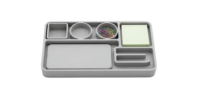 A modern grey desk organizer tray with multiple compartments holding colorful paper clips and a stack of sticky notes, viewed from a high angle in a clean, minimalist style