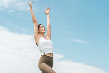 Obraz premium Young Asian woman doing park yoga, yoga, pilates, stretching in forest/park 