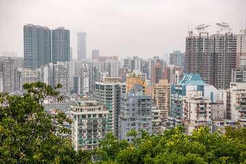 Top view on the residential district of Macau behind the trees