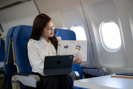 Businesswoman conducting online presentation during airplane travel