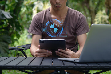 Man Using Tablet in Nature with Network Security Concept Overlay