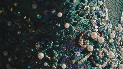 Close-up of Luxurious Teal Embellished Fabric with Shimmering Pearls and Sequins, Featuring Lens Flare - Powered by Adobe