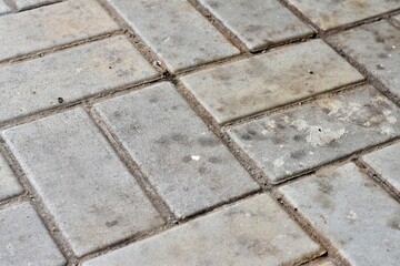 Concrete floor with visible grid lines and lightly weathered surface, ideal for industrial settings, construction themes, and street textures.