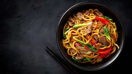 A bowl of fried noodles with meat, vegetables, and chopsticks on a dark background with copy space for text. Food menu background illustration.
