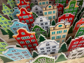 Colorful Miniature Christmas House Decorations. Festive Papercraft Display of Red, Green, White, and Blue European-Style Townhouses