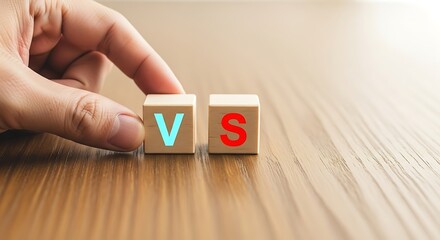 Wooden blocks displaying the letters v and s on a wooden surface