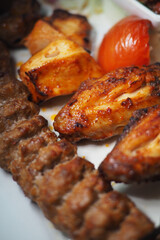 Grilled chicken and kebab meal served with vegetables