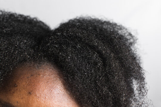 Black afro curly hair with shrinkage, Type 4c hair that is wet with a white background