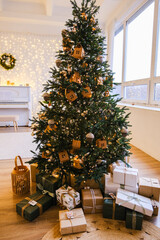 Decorated Christmas tree with lights and wrapped presents under it, symbolizing holiday celebration and gift giving for festive season.